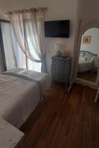 a bedroom with a bed and a dresser and a mirror at Villa Corte at Via Roma - Apartments with a View in Villa Latina