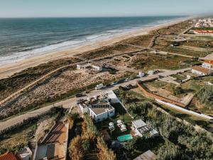 an aerial view of a beach and the ocean at We Surf House in Figueira da Foz