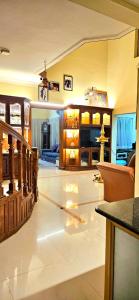 a large living room with a staircase and a living room at KRISHNAGIRI homes in Guruvāyūr