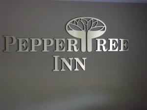 a logo for a pepperrein inc company at Pepper Tree Inn in Beaverton