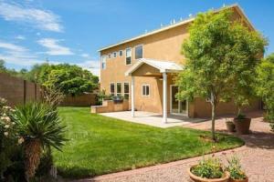 a house with a yard in front of it at Remodeled Large home w yard Gated PRIME location in Albuquerque