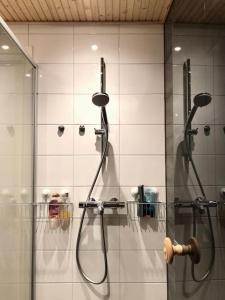 a shower in a bathroom with a glass door at Brand New and Cozy Modern Studio! WithAirCondition in Turku