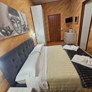 a hotel room with a large bed and a television at HOTEL RISTORANTE DELLE VALLI in Germagnano