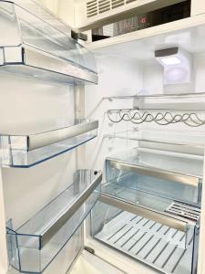 an empty refrigerator with its door open in a kitchen at Brand New and Cozy Modern Studio! WithAirCondition in Turku