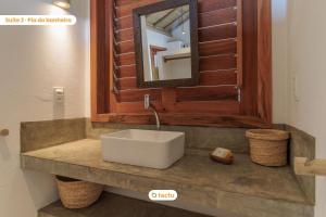 a bathroom with a white sink and a mirror at Vila Oásis, acorde com VISTA para o MAR no Fortim in Maceio +57 photos