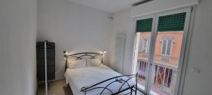 a bedroom with a bed and a window at Farolfi Apartments Galliera Rooms & Apartments in Bologna