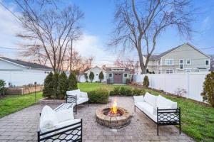 a backyard with a fire pit with white couches at Stylish Luxury 3bd home in Downtown Birmingham in Birmingham