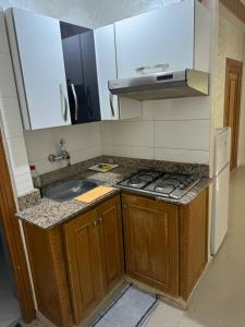a small kitchen with a sink and a stove at B 2 bedroom apartment in Fez
