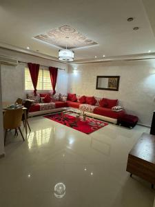 a living room with red couches and a table at B 2 bedroom apartment in Fez