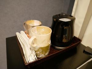 a tray with a coffee maker and cups on a counter at HOOD - Vacation STAY 46328v in Amami