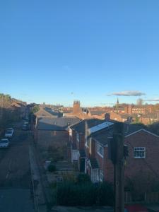 a view of a residential neighbourhood with houses and a street at Macc Apartment in Macclesfield