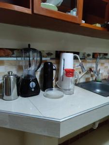 a kitchen counter with a blender on a counter top at Departamento 4 camas 3 hab in Tacna