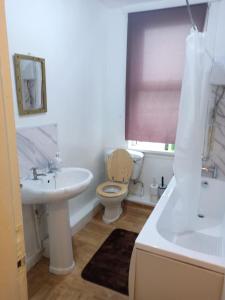 a bathroom with a sink and a toilet and a tub at Beautiful 1-Bed House in Leeds in Leeds