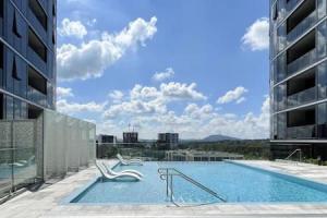 a large swimming pool on the side of a building at Tucked Away on the Tenth Floor at Woden in Phillip