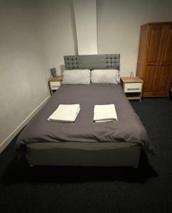 a bedroom with a large bed with two towels on it at Clifton Street in Middlesbrough
