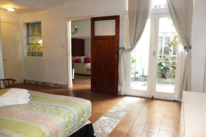 1 dormitorio con 1 cama y puerta que da a un patio en Casa San Telmo 3026 en Buenos Aires
