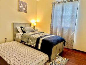 1 dormitorio con cama y ventana en Quiet Cozy 2BR APT Black out Curtains, en Peoria