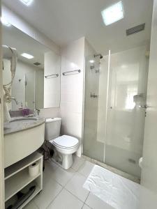 a bathroom with a toilet and a glass shower at F1611 Condomínio em Asa Norte in Brasilia