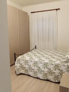 a bedroom with a bed and a window with a curtain at La Casa di Abe - Cuneo in Cuneo