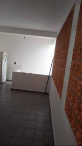 a room with a brick wall and a white wall at Quarto Disponível em Sobrado in Sao Paulo