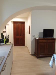 a kitchen with a hallway with a door and a television at La Casa di Abe - Cuneo in Cuneo