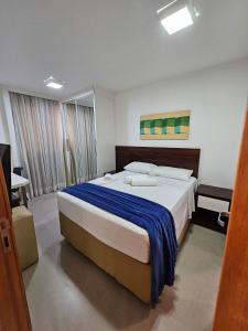 a bedroom with a large bed in a room at L207 Apartamento em resort à beira lago in Brasilia