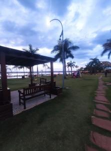 a park with benches and a street light and palm trees at L207 Apartamento em resort à beira lago in Brasilia