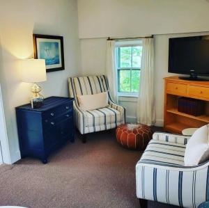 a living room with a tv and a couch and a chair at Barrington Inn Barn in New Shoreham