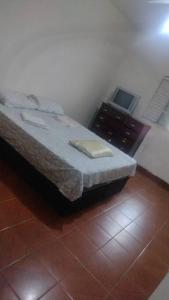 a bedroom with a bed and a desk with a laptop at casa próximo a John boy dunlop in Campinas