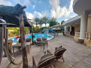 a resort with a pool with chairs and a swimming pool at Resort altayar Villa altayar 2- Aqua Park in Sidi Kirayr