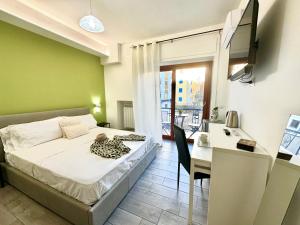 a bedroom with a bed and a desk and a table and chair at center SUITE sorrento baby 2 in Sorrento