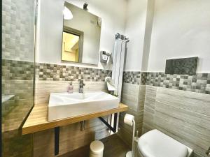 a bathroom with a sink and a toilet at center SUITE sorrento baby 2 in Sorrento