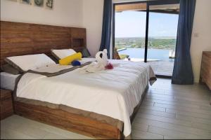 Postel nebo postele na pokoji v ubytování Villa Teranga avec vue panoramique sur la baie de Tamarin