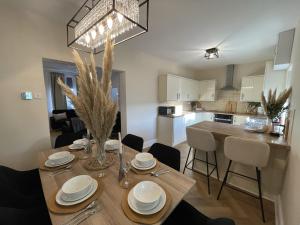 a dining room and kitchen with a table and chairs at Château by the Sea - Luxury hotel style 3 bed with hot tub in Newbiggin-by-the-Sea
