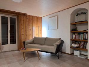 a living room with a couch and a coffee table at App 2-3 p Lake View Vallée de Joux in Le Pont