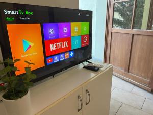 a flat screen tv sitting on top of a cabinet at Fantomas Apartments*** TH 32.1 - 3 Bedroom+Living room Apartments in Szombathely