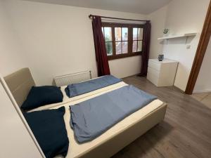 a bedroom with two beds and a window at Fantomas Apartments*** TH 32.1 - 3 Bedroom+Living room Apartments in Szombathely +1 photo