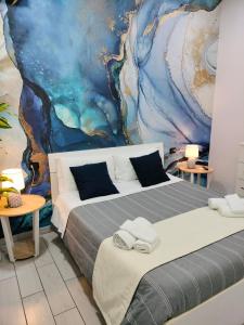 ナポリにあるB&B Anema&Coreのベッドルーム1室(ベッド2台付)が備わります。壁には絵画が飾られています。