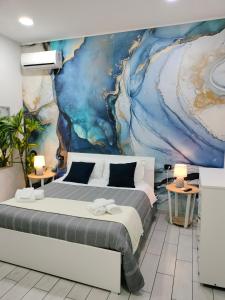 ナポリにあるB&B Anema&Coreのベッドルーム1室(ベッド1台付)が備わります。壁には絵画が飾られています。