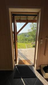 an open door to a porch with a view at Sentral og romslig leilighet nært Senja in Finnsnes