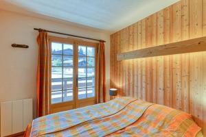 a bedroom with a bed and a large window at Ski nest - Pool - Mont Blanc view in Saint-Gervais-les-Bains