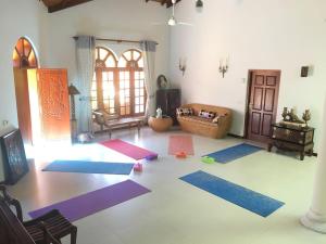 a living room with yoga mats on the floor at Caro Villa in Induruwa