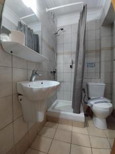 a bathroom with a sink and a toilet at Piraeus Acropole Hotel in Piraeus