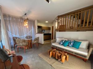 a living room with a couch and a table at Villa Sapê 9 in São Miguel dos Milagres