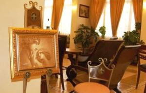 a room with chairs and a picture of a man at Aegeon Hotel in Karlovasi