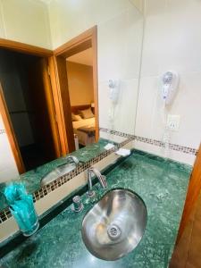 a bathroom with a sink and a mirror at Ranqueles in Villa Carlos Paz