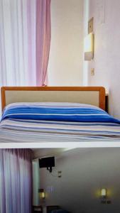 Ένα ή περισσότερα κρεβάτια σε δωμάτιο στο Hotel Saint Raphaele