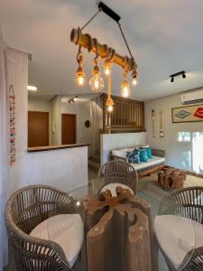 a dining room with a glass table and chairs at Villa Sapê 9 in São Miguel dos Milagres +30 photos