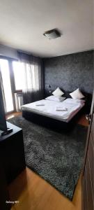 A bed or beds in a room at Penzion Ivka