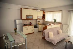 a kitchen with a couch and a table in a room at Groovy Apartment in Tripoli